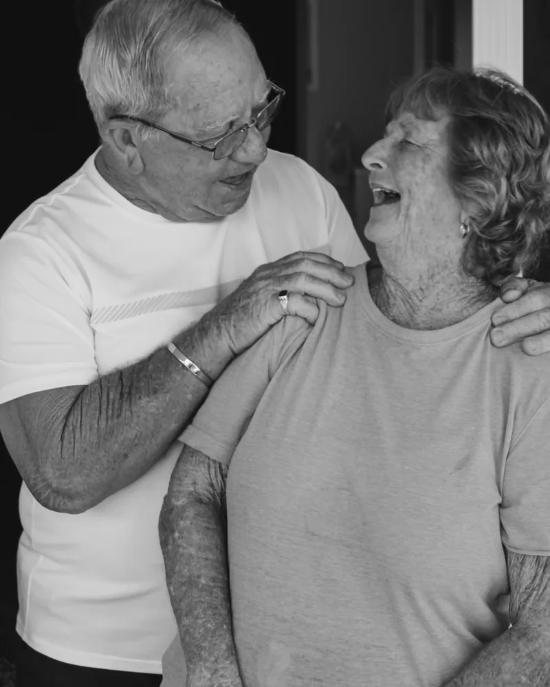 Two people in their seventies, laughing together